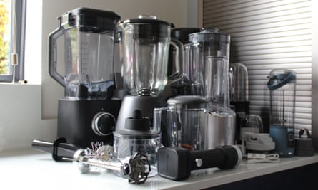 Several food blenders lined up on a kitchen work surface