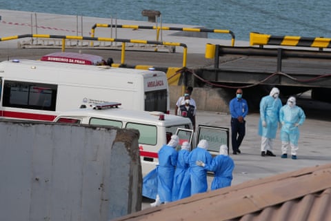 Health workers in protective gear evacuate patients from the MV Hondius cruise ship.