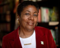 Author and new children's laureate of the UK, Patrice Lawrence, wearing a white top with a red jacket, jewellery and earrings
