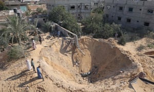 Rafah, Gaza Strip: Palestinians inspect a crater following three days of conflict with Israel