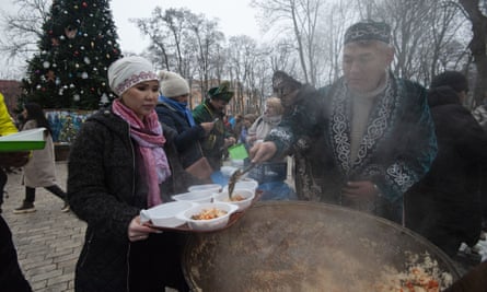 Members of Kazakh diaspora preparing food at “Invincibility yurt” in Kyiv where people can charge their phones and warm up.