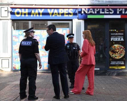 Andy Burnham and Angela Rayner talk with police officers outside a vape shop
