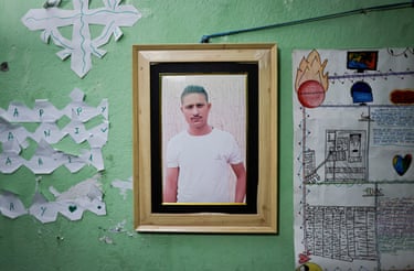 A framed photo of Dev Kumar Subedi hangs on a green wall