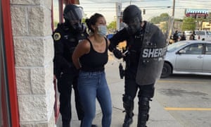 Police officers are shown arresting Des Moines Register reporter Andrea Sahouri after a Black Lives Matter protest she was covering on 31 May 2020 in Des Moines, Iowa, was dispersed by tear gas.