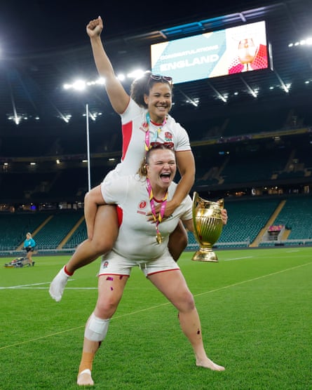 Sarah Bern and Tatyana Heard (top) of England pose for a photo with the trophy on the Twickenham pitch.