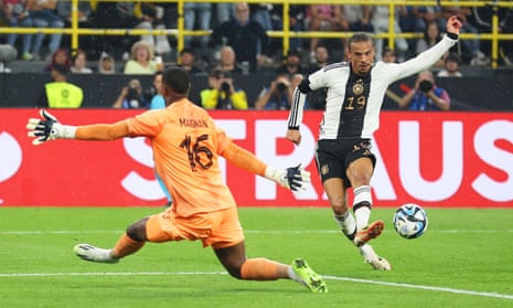 Leroy Sané scores Germany’s decisive second goal past Mike Maignan to seal the win against France
