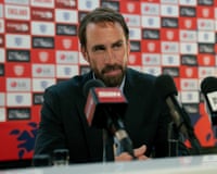 A man at press conference in front of microphones