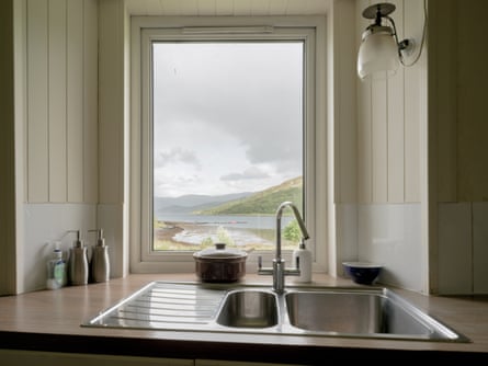 View through kitchen window of hills and sea – almost looks like a painting in a frame.