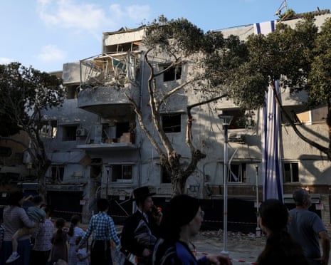 People gathered at the site of an Iranian strike in Haifa, Israel, at the weekend