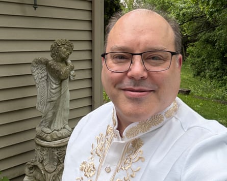 a man smiling in glasses