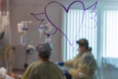 A heart with wings is drawn on the window as nurses care for a Covid-19 patient inside the ICU at Adventist Health in Sonora, California on 27 August 2021. 