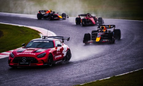 Max Verstappen follows the safety car amid heavy rain at the Suzuka Circuit.