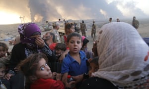 Refugees arrive in Al Qayyarah town, controlled by the Iraqi army, after fleeing Mosul after the operation to retake the city began.