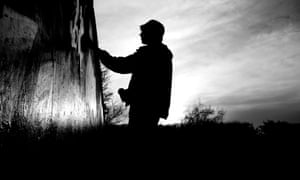 Silhouette of man doing graffiti in London