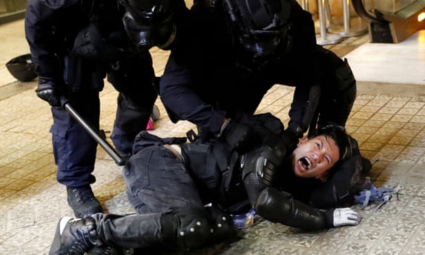 Police detain a protester on Saturday