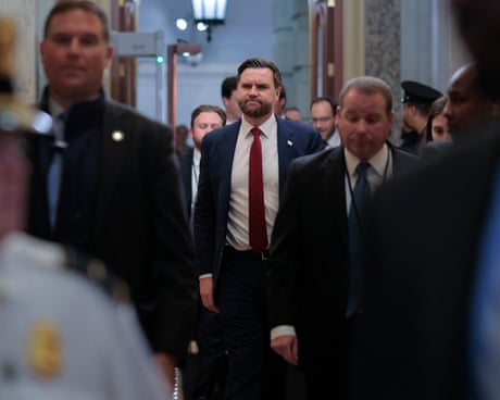 JD Vance in a suit surrounded by dozens of people walking through the Rotunda
