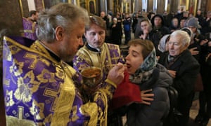 Russian Orthodox believers receive communion in Kazan Cathedral, St Petersburg