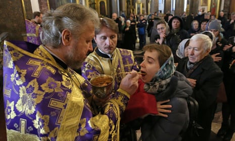 Russian Orthodox believers receive communion in Kazan Cathedral, St Petersburg