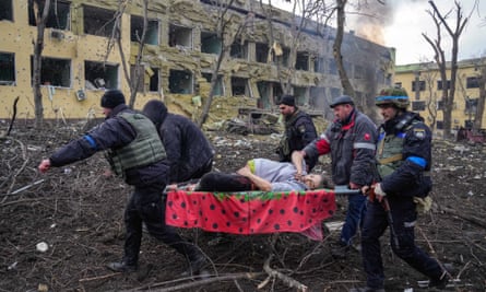 Ukrainian emergency employees and volunteers carry an injured pregnant woman from a maternity hospital that was damaged by shelling in Mariupol, Ukraine, March 9, 2022. 