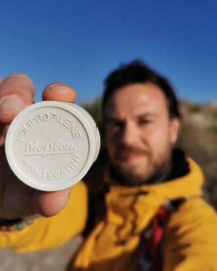 Suma holding out a 1958 Italian bottle cap towards the camera.