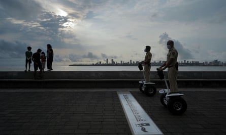 Police officers patrol on Segways along a promenade in Mumbai, India.