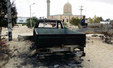 A burned truck outside Al-Rawda mosque in Bir al-Abd northern Sinai, Egypt