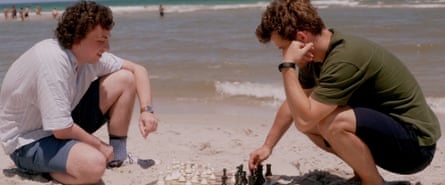Niemann, left, and Carlsen playing chess on a beach in their younger days.