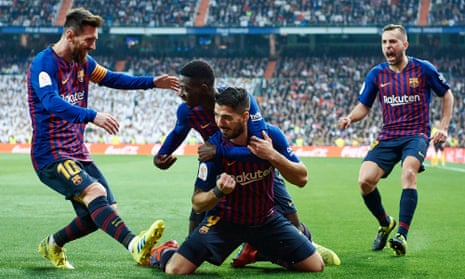  Luis Suárez is mobbed by his Barcelona teammates after after scoring his team’s opener against Real Madrid. 