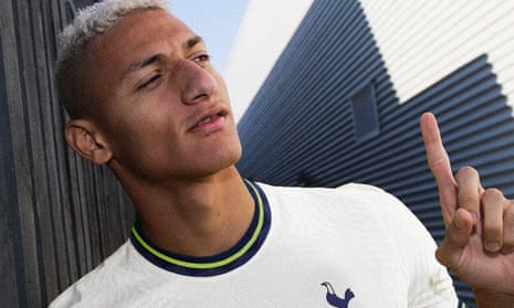 Richarlison poses in a Tottenham kit after signing for the club.
