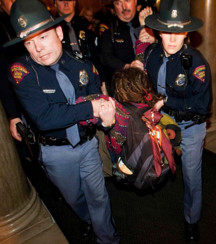 Wisconsin state troopers remove a protestor from the state Capitol, 10 March 2011. The state’s Republican governor, Scott Walker, is a committed foe of unions.