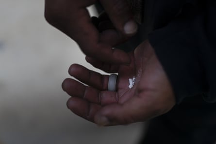 A person who is unhoused at the time of the photo holds pieces of fentanyl in Los Angeles.