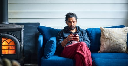 Man on sofa next to a wood burning stove