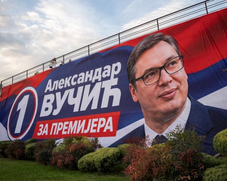 A huge campaign poster shows Aleksandar Vučić smiling beside a "1" logo and text