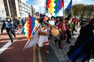 Indigenous leaders march in ceremonial dress from Glasgow Green to the SEC