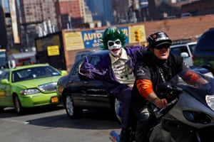 A man in costume gives the thumbs up while riding on a motorcycle en route to Comic-Con