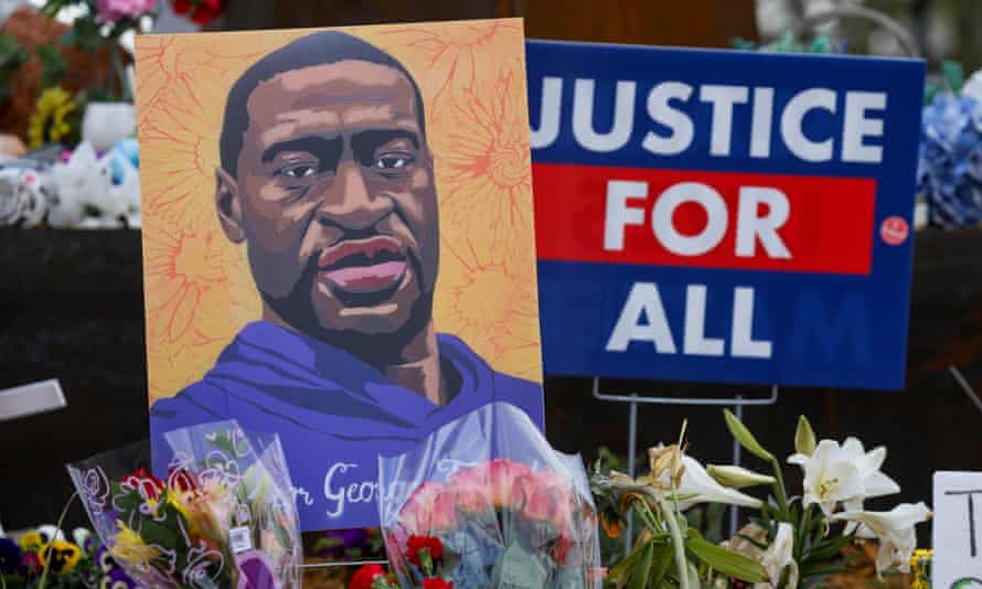People lay flowers at a memorial in George Floyd Square in Minneapolis.