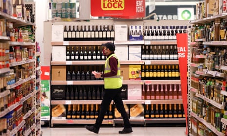 An employee walks inside a Sainsbury’s supermarket in Richmond, west London.