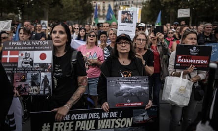 Protesters hold signs saying ‘Free Paul Watson’.
