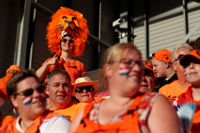 A Netherlands fan wearing a lion hat.