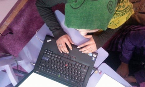 Girl in headscarf using laptop