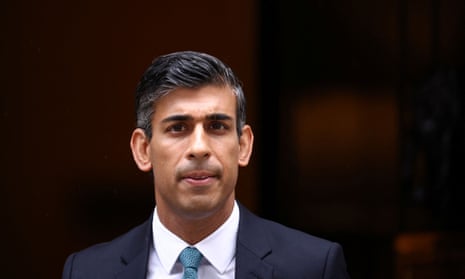 Rishi Sunak walks outside Number 10 Downing Street.