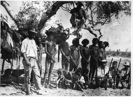 Indigenous Australians in neck chains.
