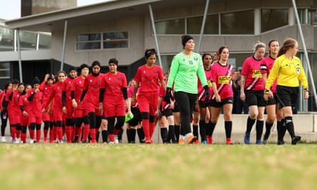 Melbourne Victory AWT players walk on the pitch with players from Melton Phoenix before a game in Australia’s seventh tier in May 2022.