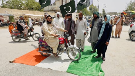 People step on an Indian flag during a rally against India in Chaman, Pakistan, 8 May.