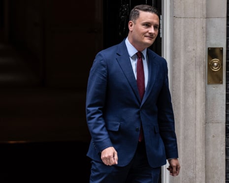 Wes Streeting exits through a black doorway