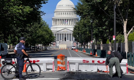 US Capitol police officers near a police barricade on Capitol Hill in Washington DC, on Sunday. A man died after driving his car into a barricade and firing shots into the air before turning his gun on himself.
