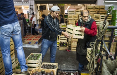 Workers with crates of avocados at a market in Mexico City.