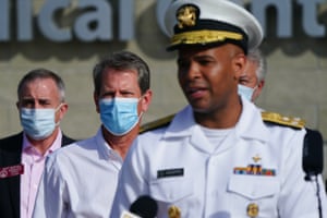 Brian Kemp, governor of Georgia, center, listens while Vice Admiral Jerome Adams, U.S. Surgeon General, speaks during a ‘Wear A Mask’ tour stop in Dalton, Georgia, U.S., on Thursday, July 2, 2020. Governor Kemp on Wednesday expressed his skepticism about the need for a statewide mask mandate and his reluctance to impose one, calling it an issue he feels is “overpoliticized.”