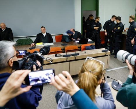 Defendant (C-L) talks with his lawyer Michael Loewe (C-R) as he waits at court for his verdict in his trial for spying for Moscow and readying attacks on critical military infrastructure and industry in a court in Munich, southern Germany.