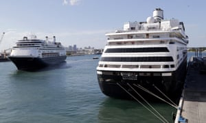 Carnival’s Holland America cruise ship Rotterdam, left, arrives at Port Everglades as the Zaandam, right, is docked in Florida.